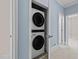 Hallway laundry closet featuring a stacked washer and dryer unit at 111 Finsbury Street St, Durham, NC 27703