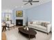 Cozy living room with a fireplace, comfortable seating, and a dining area in the background at 111 Finsbury Street St, Durham, NC 27703