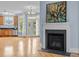Elegant living room with a fireplace, hardwood floors, and doors to the outdoor space at 111 Finsbury Street St, Durham, NC 27703