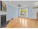 Light-filled living room featuring hardwood floors, a fireplace, and large windows at 111 Finsbury Street St, Durham, NC 27703
