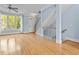 Bright living area with hardwood floors, a staircase, and large windows providing natural light at 111 Finsbury Street St, Durham, NC 27703