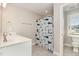 Bathroom featuring a single sink vanity, shark shower curtain, and toilet at 111 Laporte Path, Garner, NC 27529