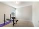 Neutral bedroom featuring gym equipment and a window at 111 Laporte Path, Garner, NC 27529
