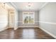 Well-lit, open dining room with hardwood floors and neutral wall color at 111 Laporte Path, Garner, NC 27529