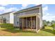 Rear exterior of home featuring a screened porch and gray siding at 111 Laporte Path, Garner, NC 27529