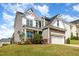 Charming two-story home with manicured lawn and a stone-accented two-car garage at 111 Laporte Path, Garner, NC 27529