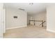 Open upstairs hallway with tan carpet, white walls and railing overlooking the stairwell at 111 Laporte Path, Garner, NC 27529
