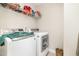 Bright laundry area features a modern washer and dryer, and convenient overhead shelving at 111 Laporte Path, Garner, NC 27529