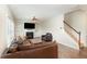 Comfortable living room featuring a fireplace, built-in shelves, and staircase at 111 Laporte Path, Garner, NC 27529