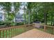 Spacious back deck overlooking a well-manicured lawn, shed, and lush green landscaping and mature trees at 1113 Smokewood Dr, Apex, NC 27502