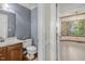 Half bathroom with wood vanity, toilet, blue wallpaper, and linoleum floors at 1113 Smokewood Dr, Apex, NC 27502