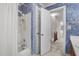 Bathroom featuring tiled shower/tub and a doorway leading to a carpeted hallway with stairs at 1113 Smokewood Dr, Apex, NC 27502