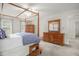 Bedroom features a wooden four-poster bed, a wooden dresser, and carpeted floors at 1113 Smokewood Dr, Apex, NC 27502