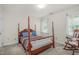 Cozy bedroom featuring a four-poster bed and rocking chair at 1113 Smokewood Dr, Apex, NC 27502