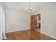 Formal dining area with hardwood floors and a stylish chandelier, perfect for entertaining at 1113 Smokewood Dr, Apex, NC 27502