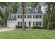 Charming two-story home with light-yellow siding, blue shutters, and a well-manicured lawn at 1113 Smokewood Dr, Apex, NC 27502