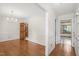 Inviting home hallway featuring hardwood floors, neutral paint, and elegant trim details at 1113 Smokewood Dr, Apex, NC 27502
