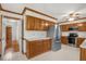 Spacious kitchen with stainless steel fridge, wood cabinetry, and ample counter space at 1113 Smokewood Dr, Apex, NC 27502