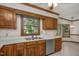 Well-lit kitchen featuring stainless steel appliances, wood cabinetry, and a practical layout at 1113 Smokewood Dr, Apex, NC 27502