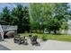 Lawn with chairs and an outdoor fireplace, with pond view at 114 Fieldstone Dr, Burlington, NC 27215