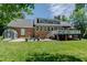 Beautiful brick home featuring a spacious backyard, deck, and outdoor seating at 114 Fieldstone Dr, Burlington, NC 27215