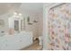 Bright bathroom featuring a vanity, stylish mirror, and a seashell themed shower curtain at 114 Fieldstone Dr, Burlington, NC 27215