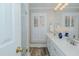 Bright bathroom featuring double sinks, white cabinets, and a shower with geometric tile at 114 Fieldstone Dr, Burlington, NC 27215