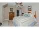 Cozy bedroom with a ceiling fan, a wooden dresser, and a plush patterned rug at 114 Fieldstone Dr, Burlington, NC 27215