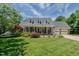 Charming brick home featuring a well-manicured lawn, a two-car garage and a welcoming covered front porch at 114 Fieldstone Dr, Burlington, NC 27215