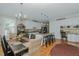 Spacious kitchen and dining area with granite counters, white cabinets, stainless appliances, and wood floors at 114 Fieldstone Dr, Burlington, NC 27215