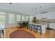 Bright eat-in kitchen boasts stainless appliances, granite countertops, island seating, and a charming breakfast nook at 114 Fieldstone Dr, Burlington, NC 27215