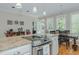 Bright kitchen with white cabinetry, an island cooktop, and an eat in kitchen area at 114 Fieldstone Dr, Burlington, NC 27215