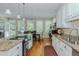 Bright kitchen with stainless steel appliances, granite countertops, and an adjacent dining area at 114 Fieldstone Dr, Burlington, NC 27215