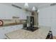 This gourmet kitchen features white cabinetry, stainless appliances, and a large granite island with a smooth cooktop at 114 Fieldstone Dr, Burlington, NC 27215