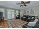 Inviting living room with hardwood floors, a ceiling fan, and French doors leading to the backyard at 114 Fieldstone Dr, Burlington, NC 27215