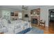 Cozy main bedroom with brick fireplace, ceiling fan, wood floors, and ample natural light at 114 Fieldstone Dr, Burlington, NC 27215