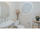 Neutral powder room featuring pedestal sink, decorative mirror, and a stylish wall-mounted medallion at 114 Fieldstone Dr, Burlington, NC 27215