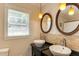 Charming bathroom with double sink vanity, granite counters, and decorative mirrors at 1206 Ivy Ln, Raleigh, NC 27609