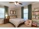 Cozy bedroom features a ceiling fan, large windows, and stuffed animal decor at 1206 Ivy Ln, Raleigh, NC 27609