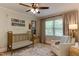 bedroom featuring a crib, comfortable chair, and lots of natural light at 1206 Ivy Ln, Raleigh, NC 27609