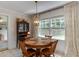 Cozy dining room features an antique hutch, chandelier, and bright window views at 1206 Ivy Ln, Raleigh, NC 27609