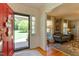 Warm and inviting foyer featuring hardwood floors, a bright red door, and an open view to the living area at 1206 Ivy Ln, Raleigh, NC 27609