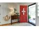 Inviting foyer with a striking red door, elegant decor, and warm, welcoming ambiance at 1206 Ivy Ln, Raleigh, NC 27609