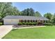 Beautiful brick home with a well-maintained lawn and an inviting bench, perfect for enjoying the outdoors at 1206 Ivy Ln, Raleigh, NC 27609