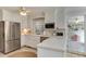 Bright white kitchen with stainless steel appliances, ample counter space, and charming breakfast area at 1206 Ivy Ln, Raleigh, NC 27609