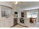 Well-maintained white kitchen featuring stainless steel appliances and an adjacent cozy breakfast nook at 1206 Ivy Ln, Raleigh, NC 27609