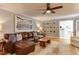 Spacious living room with a comfortable leather sectional, hardwood floors, and stylish decor at 1206 Ivy Ln, Raleigh, NC 27609