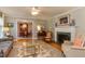 Comfortable living room with fireplace and glass coffee table, plus view into the dining room at 1206 Ivy Ln, Raleigh, NC 27609