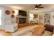 Cozy living room features a brick fireplace, hardwood floors, and comfortable seating at 1206 Ivy Ln, Raleigh, NC 27609