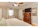 Bright main bedroom featuring a ceiling fan, light walls, and mounted television at 1206 Ivy Ln, Raleigh, NC 27609